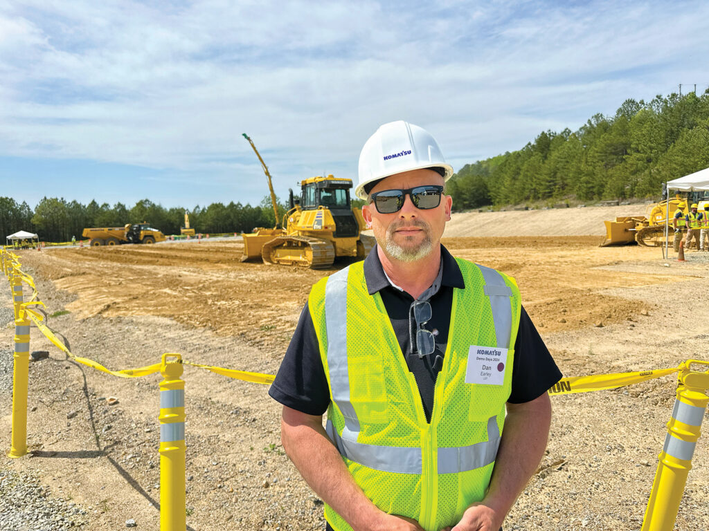 An image of Dan Earley, Co-owner of Lei, wearing a white hard hat and a reflective vest at Demo Days.