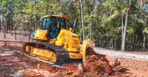 A Komatsu D61PXi-24 dozer moving dirt, demonstrating the use of IMC dozers by Russell Lands Inc.