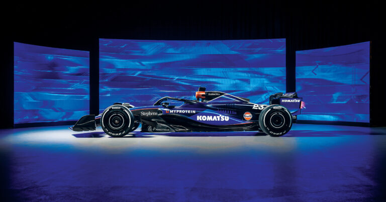 A blue Williams Racing race car adorned with prominent Komatsu branding.